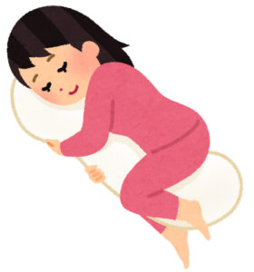 抱き枕を抱えている女性のイラスト
